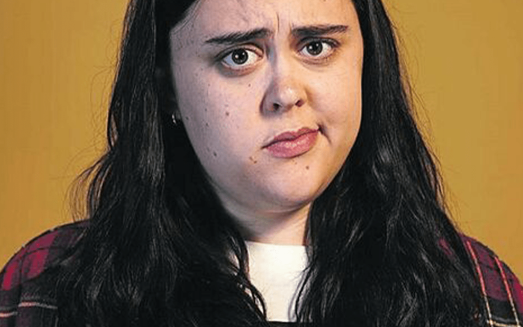 This is Sharon Rooney  against a white background looking confused or discomforted, much like her entire presence in "My Mad Fat Diary".