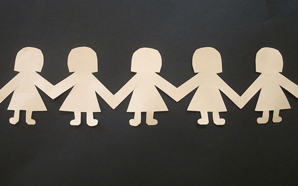 This is a five cut of figures of girls holding hands spanning accross the entire frame from left to right, representing the impenetrable friendships in "Clique".