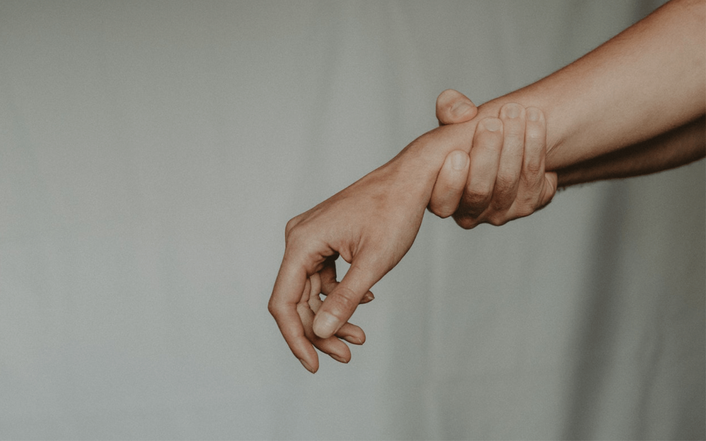 This is a person gripping the wrist of another person. The background of the picture is a light grey curtain making the abusive undertones plain and clear. This represents the abuse in "Well Intended Love".