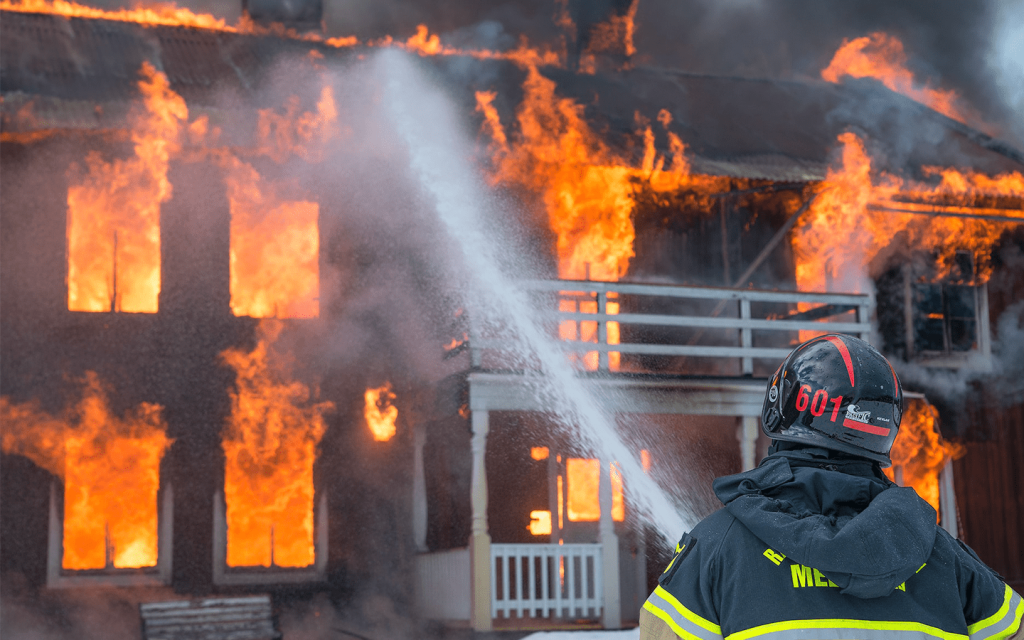 This is a firefighter holding a hose with water rushing out towards a house on fire. This represent the episode "Indoor Fireworks".