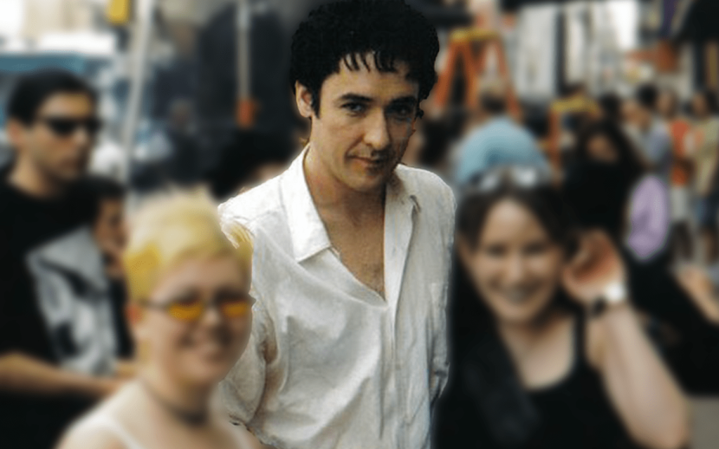 This is a picture of John Cusack with two unknown women who have been blurred out.